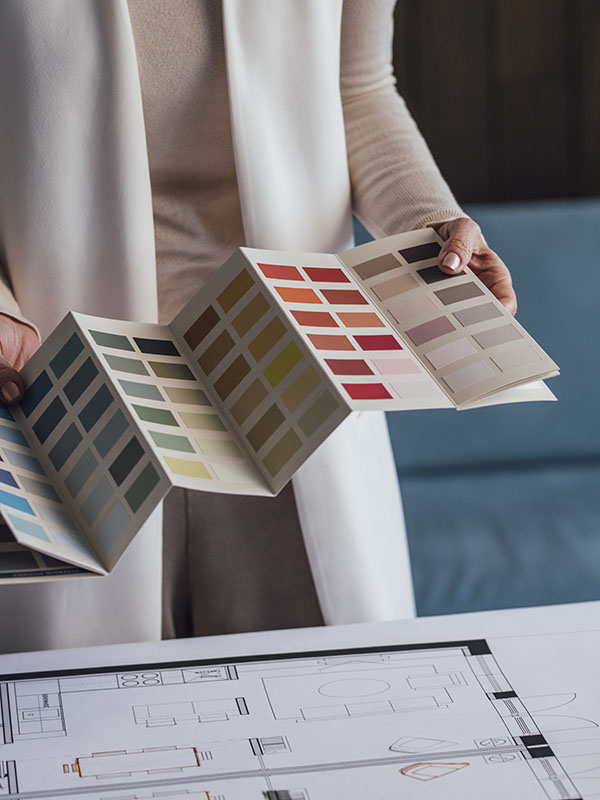 Designer selecting powder coating colours and finishes for office furniture and workplace environments.