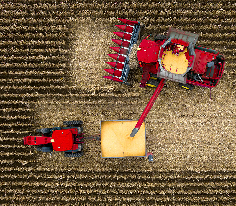 Agricultural harvesting equipment operating in Canadian farming conditions with durable powder-coated protection.