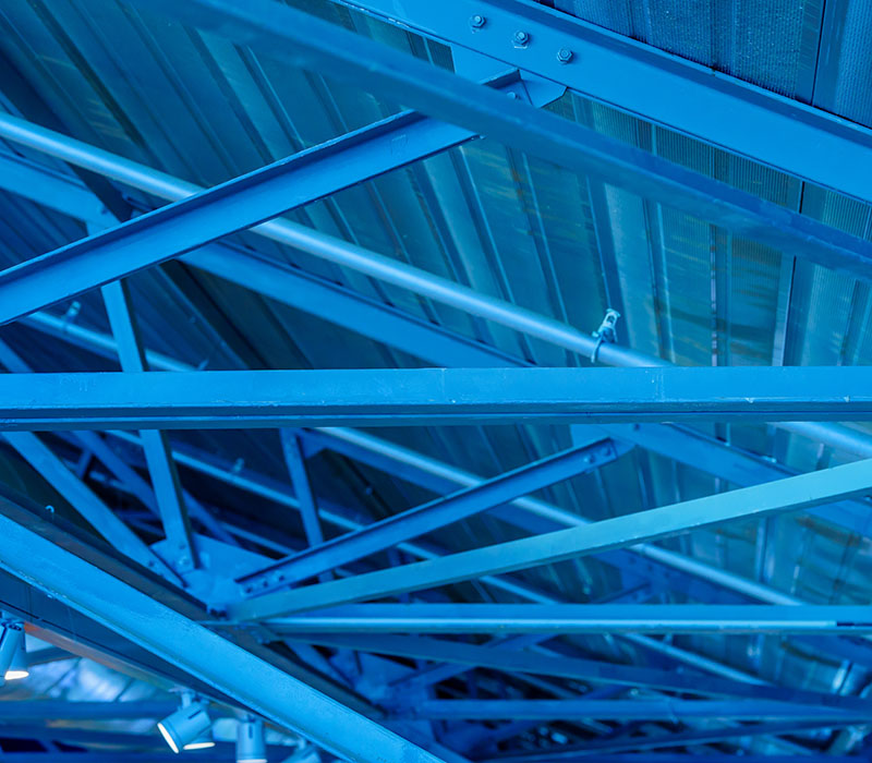 Powder-coated structural steel beams used in commercial and industrial construction projects.