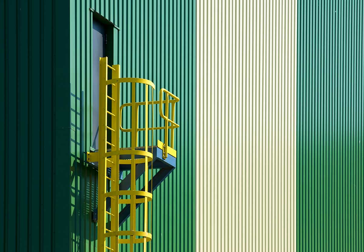 Industrial facility exterior featuring durable powder coated metal panels and safety ladder system, demonstrating high-performance coating solutions built for demanding Canadian environments.