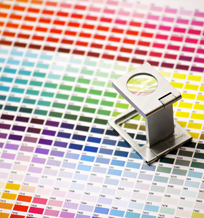 Manufacturing professionals reviewing colour and quality standards for powder coating applications.