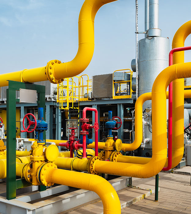 Industrial oil and gas processing facility with powder-coated piping and equipment protected from corrosion and weather exposure.