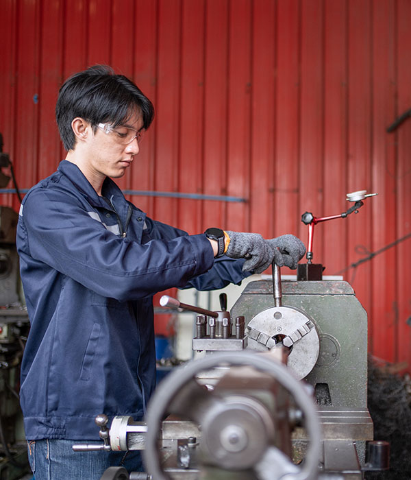 Fabrication shop technician producing custom metal components finished with high-performance powder coatings.